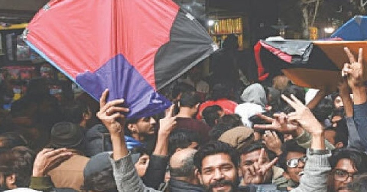 Guddas held up in a crowded Lahore kite market, the everyday size being bought