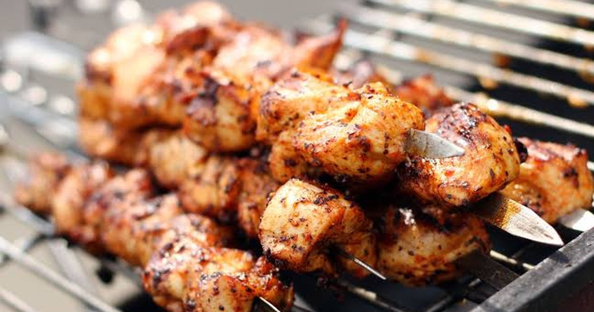 Chicken tikka skewers grilling over coals, the barbecue that comes out after dark at Basant