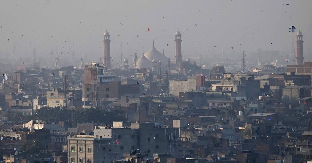 The Lahore cityscape under haze with an empty sky, no kites flying