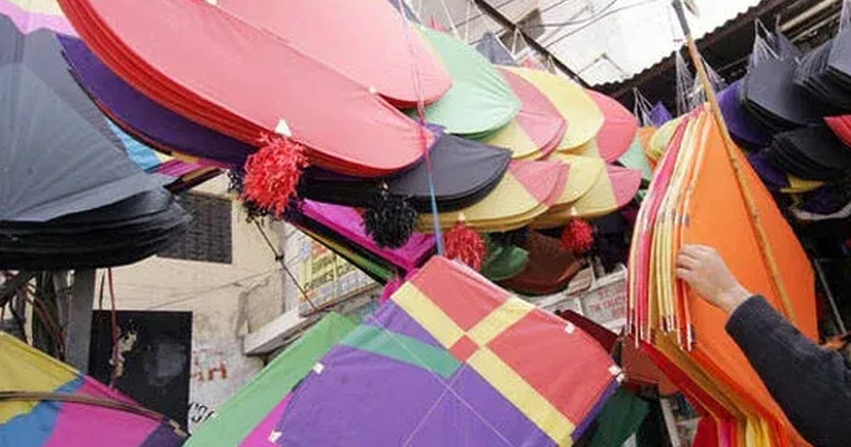 A kite shop with rows of brightly coloured kites hanging on display