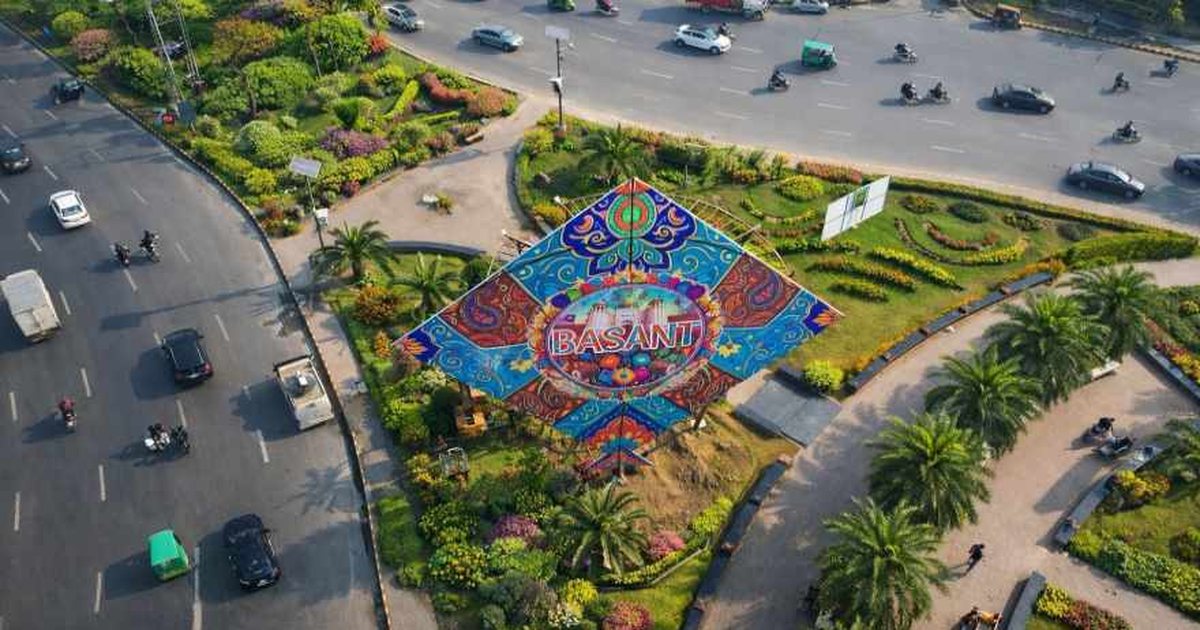 An aerial view of Lahore with a giant kite installation on a roundabout